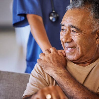 personal care Nurse or doctor offer their man support during recovery or loss. Caregiver holding hand of her sad senior patient and showing kindness while doing a checkup at a retirement, old age home or hospital